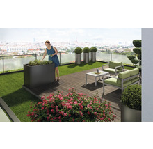 Toit-terrasse aménagé avec bac à plantes, coin salon et décorations florales