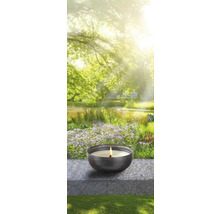 Bougie dans un bol devant un fond de jardin