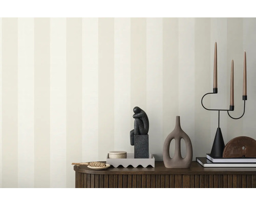 Intérieur décoratif avec papier peint, sculpture et chandelier sur un buffet.