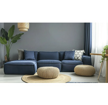Wohnzimmer mit modularem Sofa, Poufs und Zimmerpflanze für ein gemütliches Ambiente