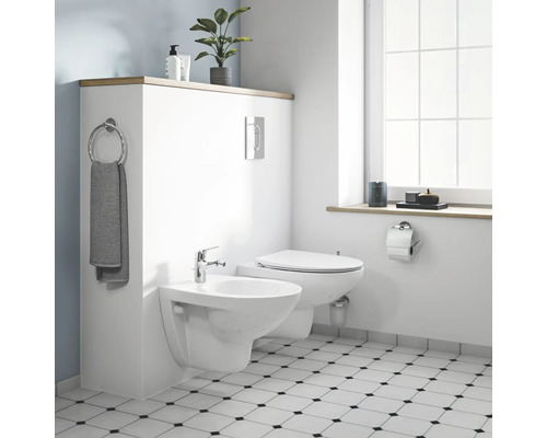 Modernes Badezimmer mit wandhängendem WC und Bidet sowie Fliesenspiegel