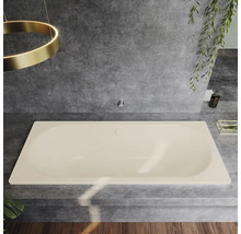 Baignoire beige dans une salle de bains avec des carreaux gris