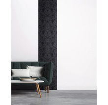 Salon avec papier peint à motifs foncés et canapé