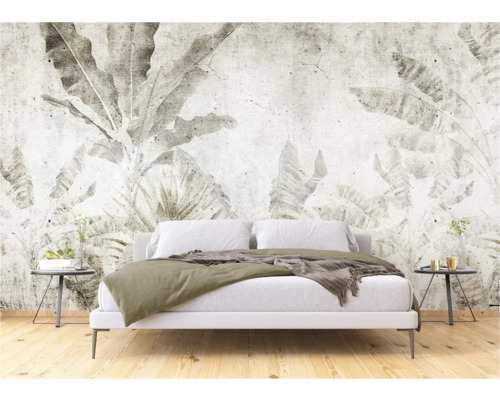 Chambre à coucher avec un papier peint mural à motifs de plantes créant une atmosphère calme.