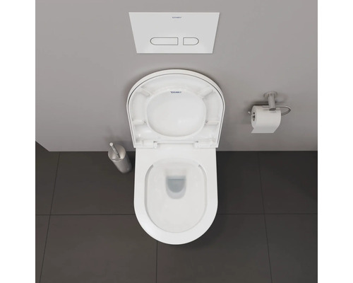 Vue de dessus de toilettes avec couvercle ouvert, brosse de toilette, porte-papier toilette et logo Duravit.