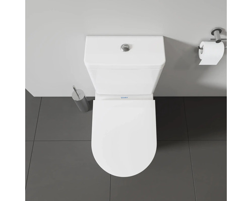 Vue de dessus de toilettes Duravit blanches avec brosse de toilettes et porte-papier hygiénique