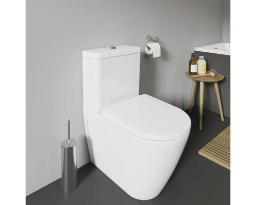Salle de bain moderne avec toilettes, porte-papier toilette, brosse et tabouret
