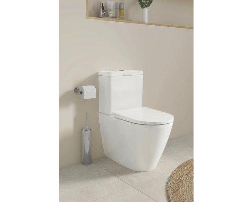 Salle de bain moderne avec toilettes, porte-papier toilette et brosse