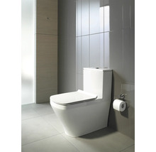Toilettes blanches dans une salle de bains avec des carreaux gris.