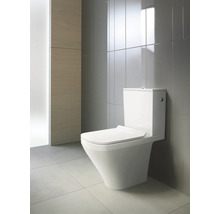 Toilettes en céramique dans une salle de bain avec des carreaux