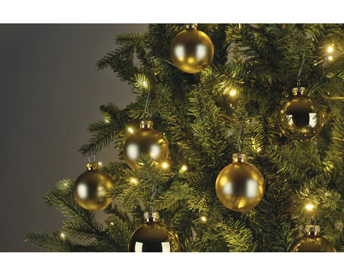 Nahaufnahme eines Weihnachtsbaums mit goldenen Kugeln und Lichtern