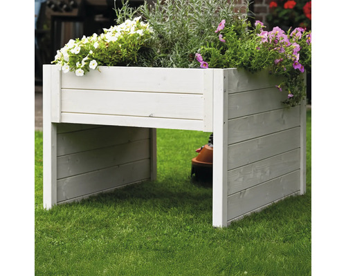 Jardinière surélevée en bois plantée de fleurs dans le jardin