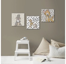 Trois tableaux sur toile avec des motifs Bambi sur un mur dans une chambre d''enfant.