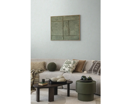 Salon avec canapé, coussins, table basse et décoration murale pour une atmosphère chaleureuse