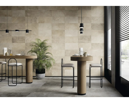 Pièce lumineuse avec carrelage mural et au sol, tables, chaises et plante d'intérieur