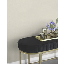 Dekorativer Hocker mit Blumen, Gläsern und goldenem Tablett.