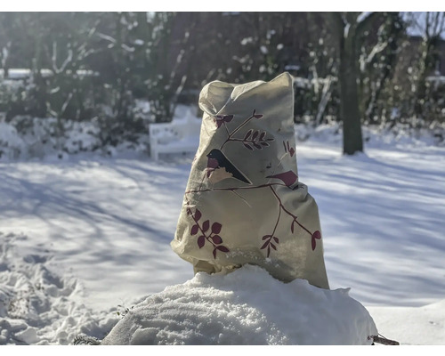 Sac de protection pour plantes avec motif d'oiseau dans un jardin enneigé