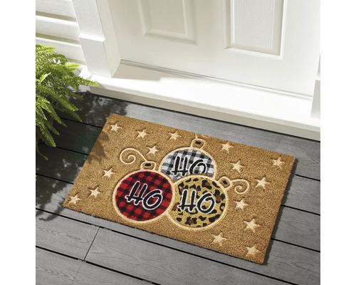Paillasson avec motif de boules de Noël devant une porte