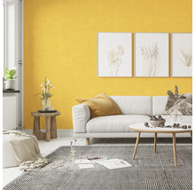 Wohnzimmer mit weißem Sofa, gemusterter Teppich und gelber Wand