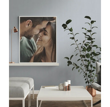 Wohnzimmer mit Foto eines Paares, Tisch, Pflanze und Lampe