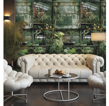Wohnzimmer mit Chesterfield Sofa, Sesseln, Tisch und Fototapete mit Pflanzenmotiven