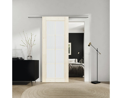 Aménagement de pièce avec porte coulissante, commode, tapis et vue sur la chambre