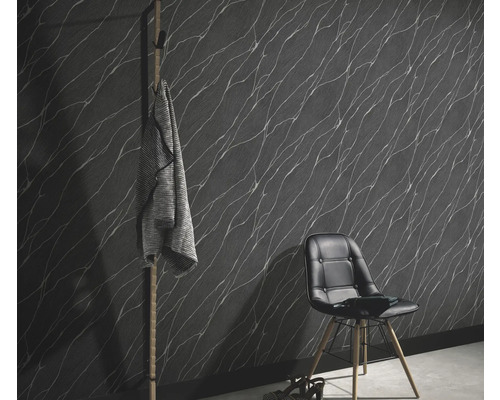 Wohnraum mit gemusterter Tapete, Stuhl und Garderobe