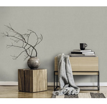 Salon avec papier peint textile, tabouret en bois et décoration pour une ambiance chaleureuse