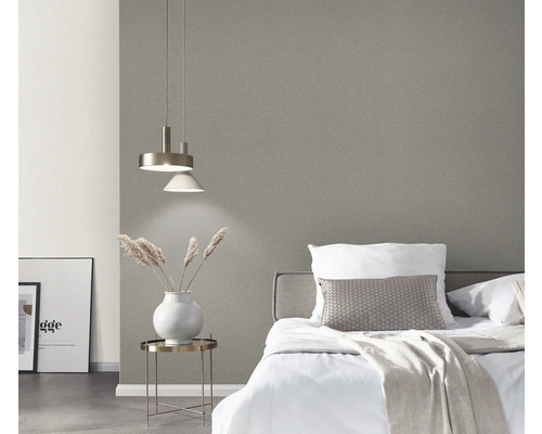 Chambre avec lit, table de chevet, lampe et papier peint gris