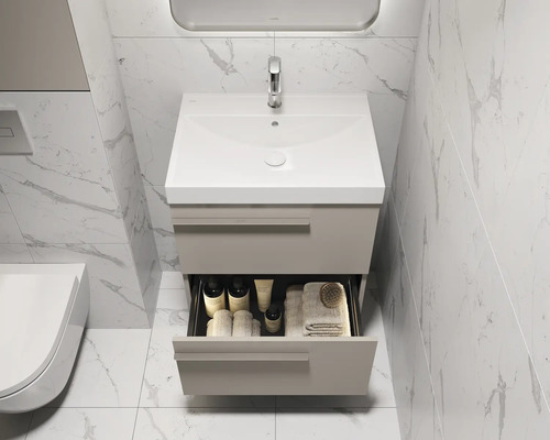 Meuble-lavabo avec tiroir dans une salle de bains avec carrelage en marbre.