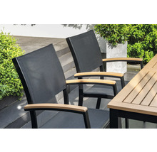 Zwei Gartenstühle mit Armlehnen aus Holz an einem Gartentisch