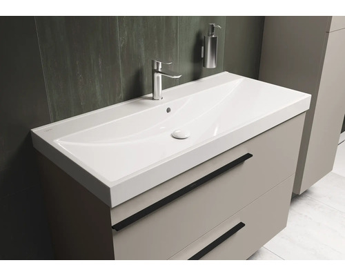 Meuble-lavabo avec lavabo, robinetterie et meuble bas à tiroirs pour la salle de bain.