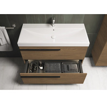 Meuble sous-lavabo avec tiroir ouvert dans une salle de bain