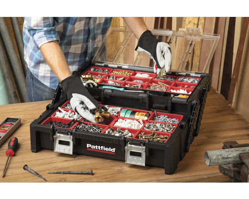 Offene schwarze Werkzeugkiste mit rotem Innenraum, gefüllt mit verschiedenen Werkzeugen und Schrauben.