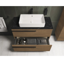 Salle de bain moderne avec meuble sous-lavabo, vasque à poser et tiroir ouvert.