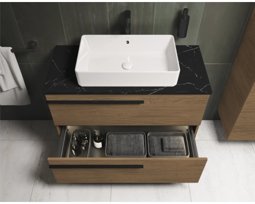 Salle de bain moderne avec meuble sous-lavabo, vasque à poser et tiroir ouvert.