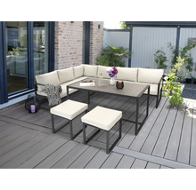 Ensemble de meubles de jardin avec canapé d'angle, table et tabourets sur une terrasse