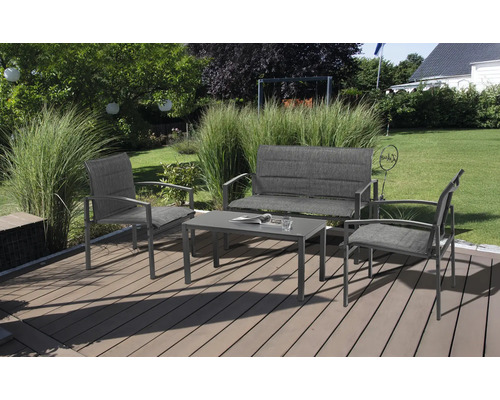 Ensemble de mobilier de jardin avec table, banc et deux chaises sur une terrasse.
