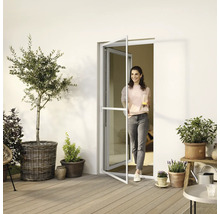 Femme entrant sur une terrasse par une porte anti-insectes