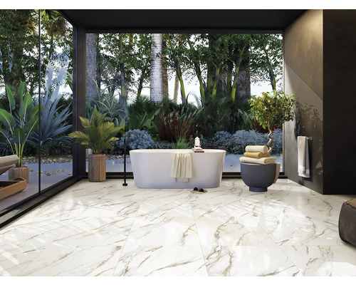 Salle de bains lumineuse avec baignoire autoportante, plantes et carrelage imitation marbre