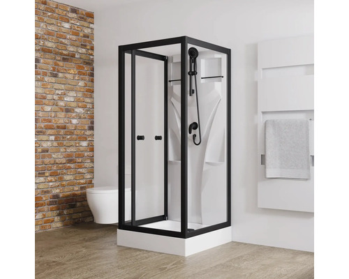 Schwarze Duschkabine mit Handtuchwärmer in einem Badezimmer mit Ziegelwand