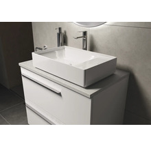 Meuble-lavabo avec vasque à poser, robinetterie et distributeur de savon dans la salle de bains