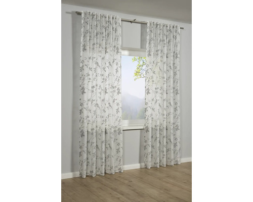 Deux rideaux transparents avec motif de feuilles devant une fenêtre