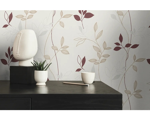 Mur décoratif avec papier peint à motif de feuilles, sculpture minimaliste et plante d'intérieur