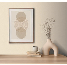 Image décorative avec motif de cercle dans un cadre en bois, sur une table avec un vase décoratif et des livres