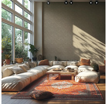 Salon lumineux avec grande baie vitrée, canapé d'angle, tapis et table en bois