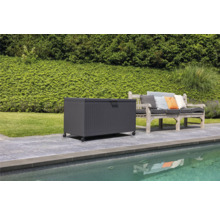 Scène avec un coffre de rangement à roulettes à côté d'un banc de jardin sur une terrasse près d'une piscine