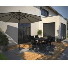 Außenbereich mit Sonnenschirm, Gartentisch und Stühlen auf einer Terrasse.