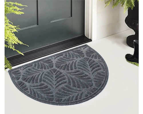 Halbrunde Fußmatte mit Blattmuster vor einer Haustür