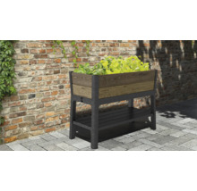 Hochbeet mit Ablagefläche und Bepflanzung vor einer Backsteinmauer